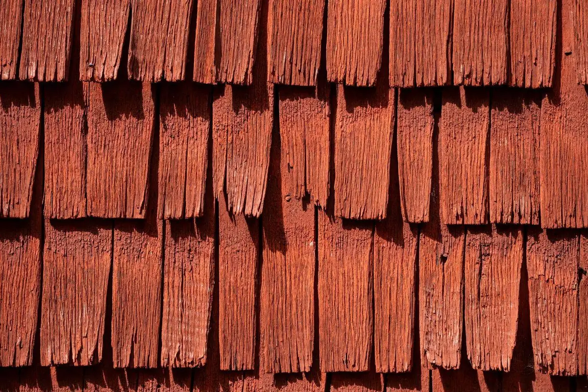 Weathered wood shingles, worn and lifting with age