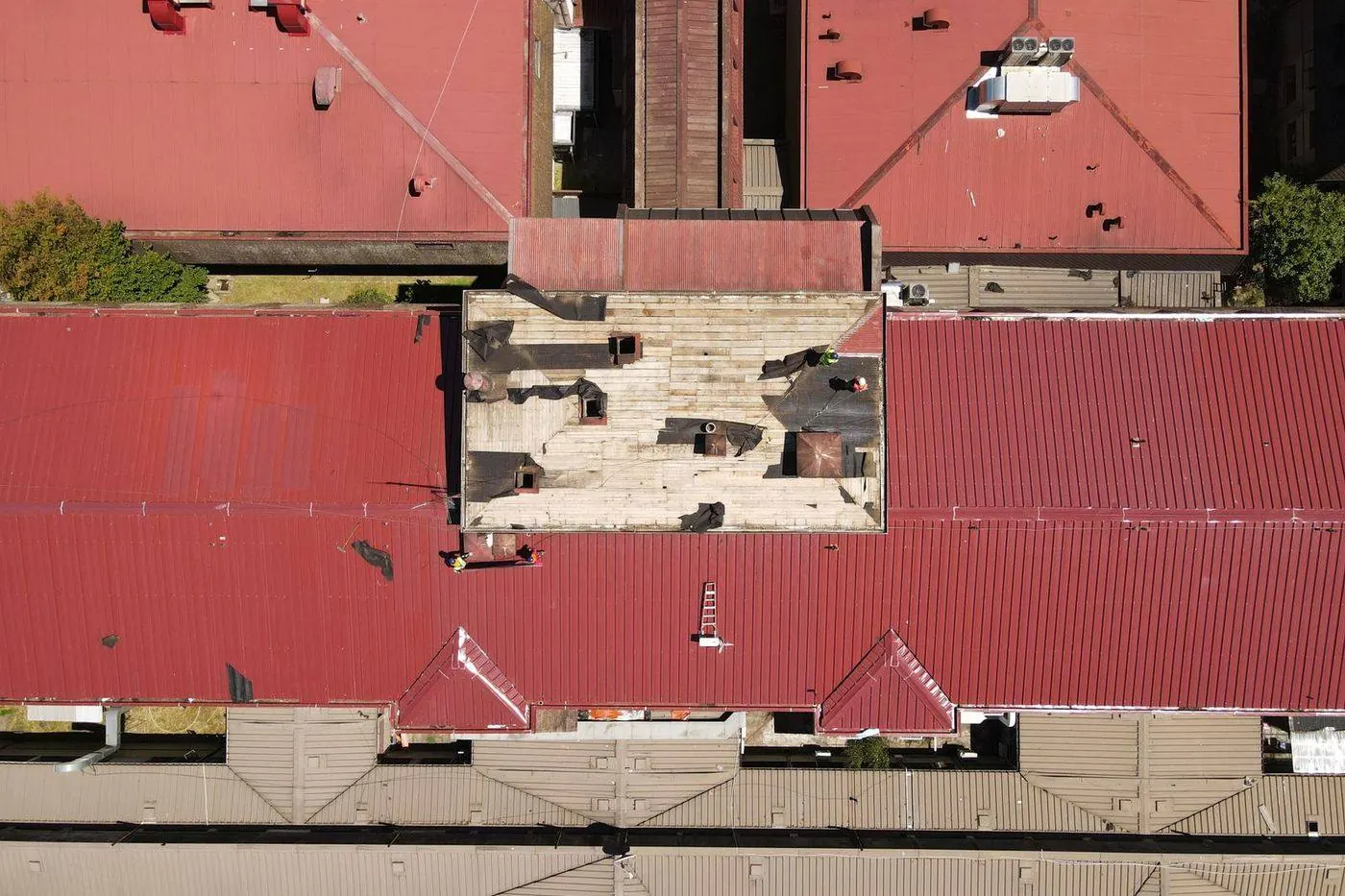 Roofer inspecting a roof for leaks